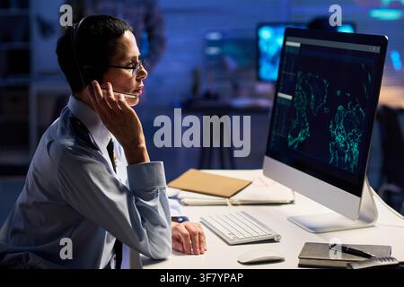 Middle Aged Woman Officer Working in Security Control Room Stock Photo