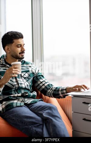 Man Working on Laptop with Coffee Stock Photo