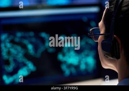 Woman Wearing Headset Working in Cyber Security Control Room Stock Photo