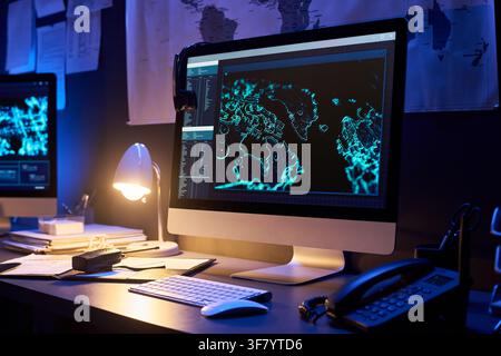 Computer Monitor Displaying Global Cyber Security Map on Office Desk Stock Photo