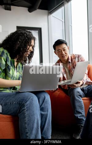 Students Collaborating on Laptops Stock Photo
