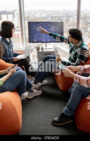 Team Discussing Car Design Blueprint Stock Photo