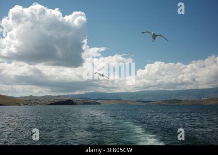 Two sons in the blue sky with clouds Stock Photo