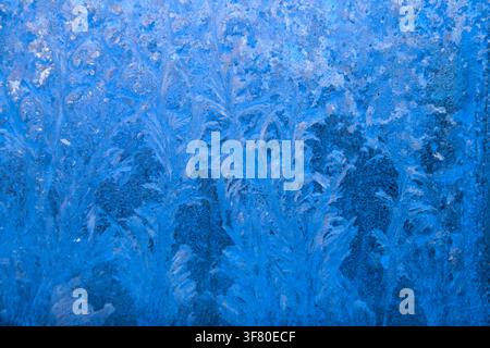 Frost pattern on a frozen window at winter. Natural background, texture Stock Photo