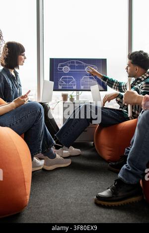 Team Discussing Car Design Blueprint Stock Photo