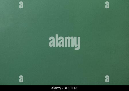Close-up of green cardstock paper with a subtle textured surface. Minimal abstract background ideal for design, branding, packaging, and creative proj Stock Photo