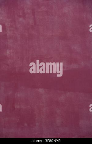Wall with smooth dark pink plaster or stucco for use as a background texture Stock Photo