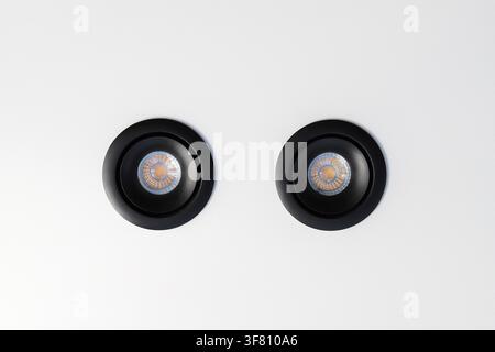 Black recessed ceiling spotlights on white Stock Photo