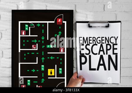 Emergency evacuation plan displayed on wall with detailed escape route in building area Stock Photo