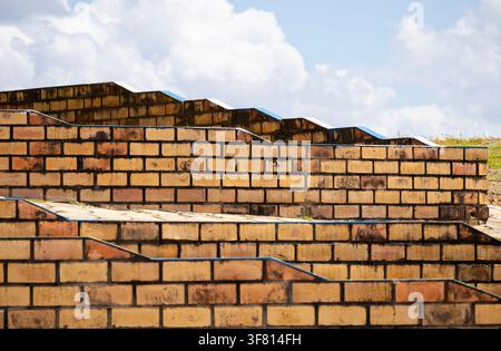 Close-up of a textured pattern red clay brick wall showing an amazing symmetry Stock Photo