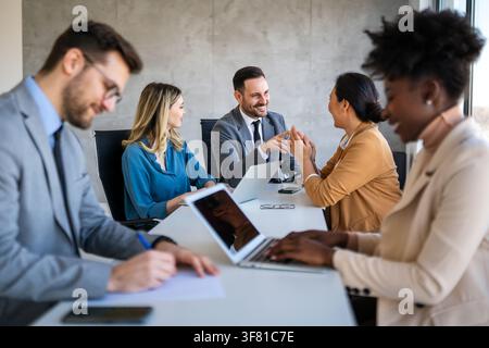 Multicultural professional businesspeople working together on research plan in boardroom. Stock Photo