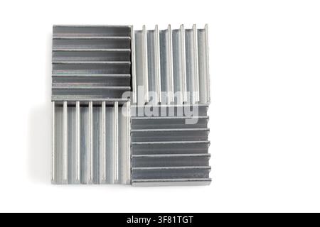 Metallic heat sinks arranged in square formation. Clean white background highlights sharp edges and texture. Ideal for tech, engineering, or industria Stock Photo