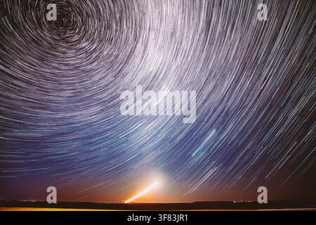 Moonrise Sky Natural Background. Unusual Amazing Stars Effect In Sky. Trace Of Moon. Spin Of Star And Meteoric Trails On Night Sky. Large Exposure Stock Photo
