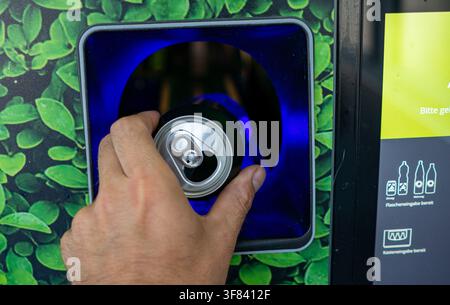 Returning Empty Bottles and Cans at a Supermarket Recycling Machine – Deposit Return, Recycling and Sustainability Concept Stock Photo