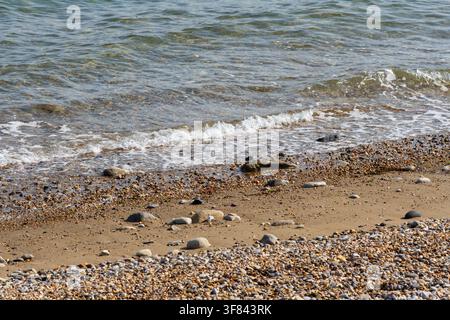 Waves breaking onto the beach Stock Photo