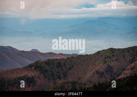 Mountain view from Shiga Kusatsu Kogen Route overlooking Nagano Valley in Japan with layered ridges and mist Stock Photo
