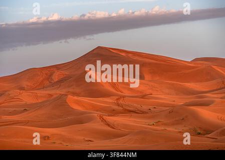 Sunlight on dunes in the Moroccan desert creates patterns shaped by the wind and time over the landscape Stock Photo