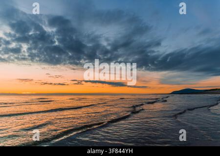 Sunset over the Irish Sea from Sandy Gap with Black Combe in the distance Stock Photo