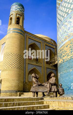 Statue showing traditional Uzbek life in Khiva with architectural features and local figures Stock Photo