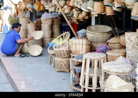 Craftsman creates woven bamboo baskets for carrying sticky rice in Luang Prabang, Laos Stock Photo