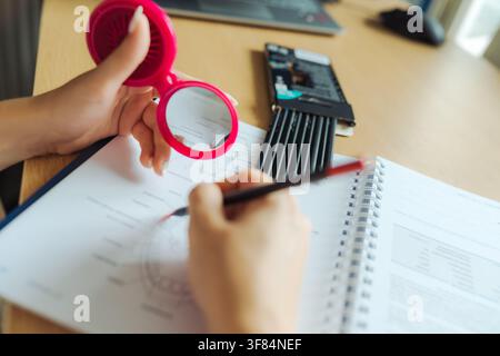 Person practicing mirror writing technique on paper Stock Photo