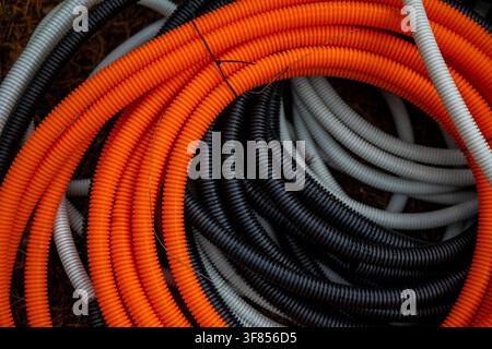 Top view of colorful plastic corrugated conduit pipes at outdoor construction site. Concept: optical fiber installation  Stock Photo