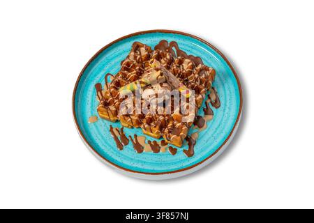 Belgian Waffles with Chocolate Gelato, Chocolate Sauce and Wafer Rolls on Blue Plate Stock Photo