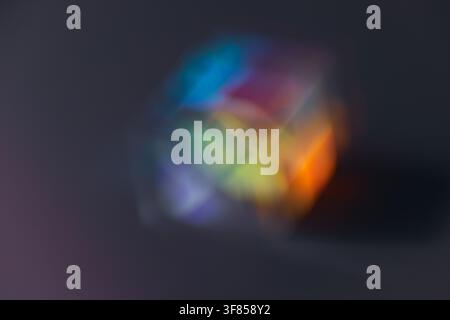 Soft blurred rainbow light refraction forming colorful circular glow on dark background for dreamy abstract design Stock Photo