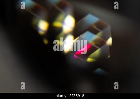 Close abstract view of glass prisms with pink and golden refracted light for dark futuristic background Stock Photo