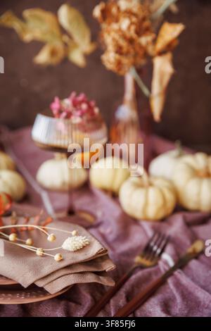 Autumn-themed dining table with pumpkins and stylish decor Stock Photo