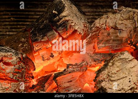 Glowing fireplace embers revealing heat and texture in a vivid close view Stock Photo