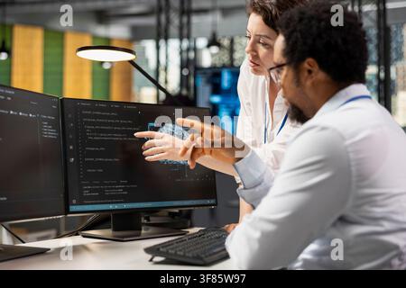 AI startup technicians working together to create deep learning models. Teamworking colleagues collaborating on artificial intelligence project, developing scalable solutions for businesses Stock Photo