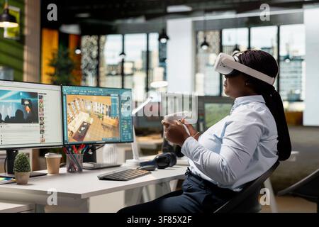Black woman working with VR glasses and architectural CAD program on PC, designing detailed apartment floor plan and 3D render model. Staff uses tools to create interior design and layout. Stock Photo