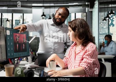Diverse photographers generating editorial photos with AI virtual assistant, using text to image software on monitor. Editors working on commercial post production with generative models. Stock Photo