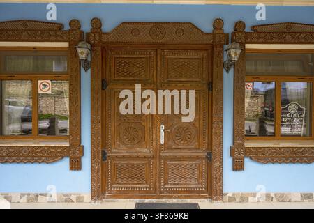 Detailed wooden door with traditional patterns and blue facade, Vila Etnica historic inn, Butuceni, Old Orhei, Orheiul Vechi, archaeological site, hi Stock Photo