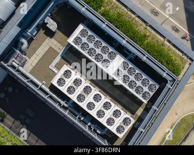 Aerial view of ai data center rooftop featuring rows of industrial cooling fans and ventilation systems on a modern building in Krakow, Lesser Poland Stock Photo