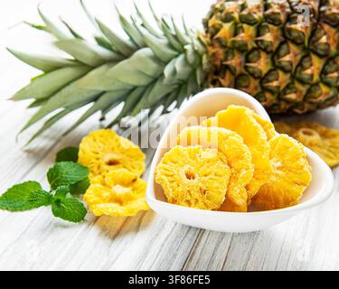 Pineapple dried rings on rustic wooden background Stock Photo
