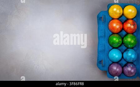 Easter concept wit colorful Easter eggs on grey background. Top view with copy space. Stock Photo