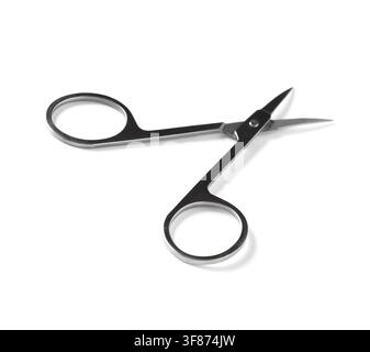 Small metal manicure scissors with sharp blades and finger holes, personal grooming and beauty tool, isolated on a white background Stock Photo