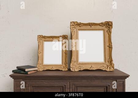 Vintage ornate frame mockup with two empty picture frames on a dark wooden mantel. Suitable for artwork, photography, posters, wall decor, gallery pre Stock Photo