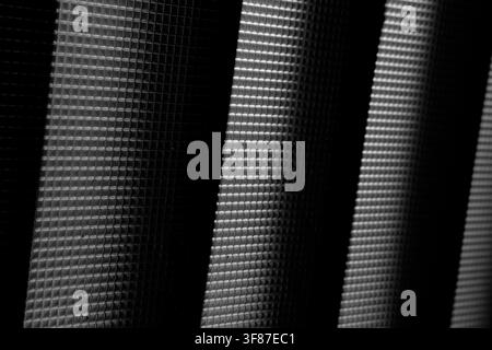 Macro photo of minimalist grid pattern with high contrast diagonal lighting. Stock Photo
