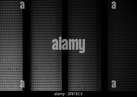 High-contrast monochrome geometric texture with rhythmic vertical shadows. Ideal for modern architectural and industrial backgrounds. Stock Photo
