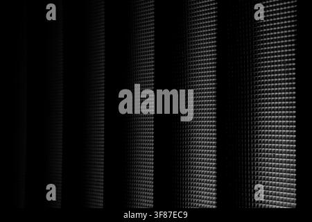 Abstract monochrome composition featuring dark textured vertical stripes and a detailed mesh grid. Suitable for technology, luxury, or architectural b Stock Photo