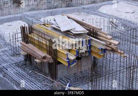 Building foundation with steel reinforcement and formwork elements for concrete pouring, illustrating the early stages of a new construction project a Stock Photo