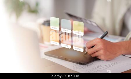 Graphic designer using stylus and digital tablet for color selection Stock Photo