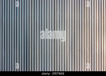 Ribbed industrial metal surface with repetitive vertical lines Stock Photo