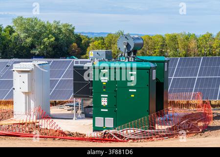 Solar farm inverter and transformer substation station to convert the electricity to the correct current for the grid Stock Photo