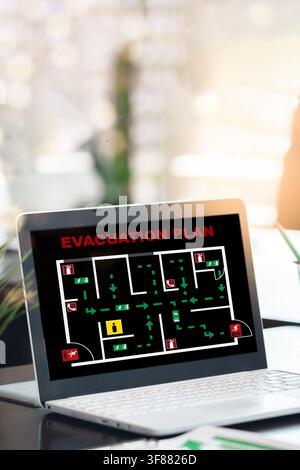 Emergency evacuation plan displayed on a laptop in an office setting Stock Photo