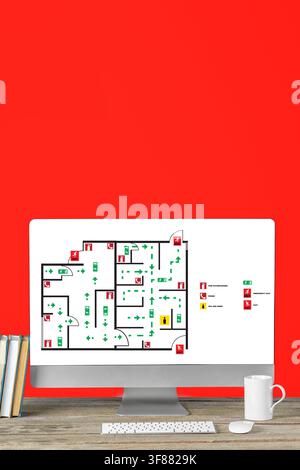 Emergency evacuation plan displayed on computer screen with a red background Stock Photo