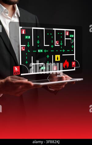 Emergency evacuation plan displayed on tablet for building safety procedures Stock Photo
